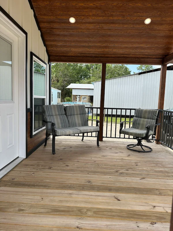 porch area with sofas in a full house series park model - Phoenix